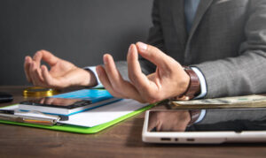 caucasian businessman meditating in office.