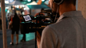 cameraman recording poeple watching football