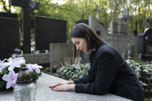 woman mourning cemetery grave