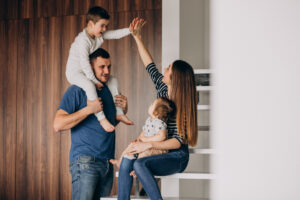 young family with their little son at home having fun