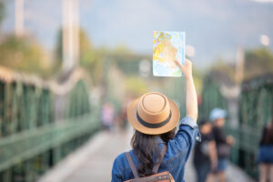 female tourists on hand have a happy travel map.