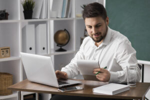 medium shot man making list with laptop